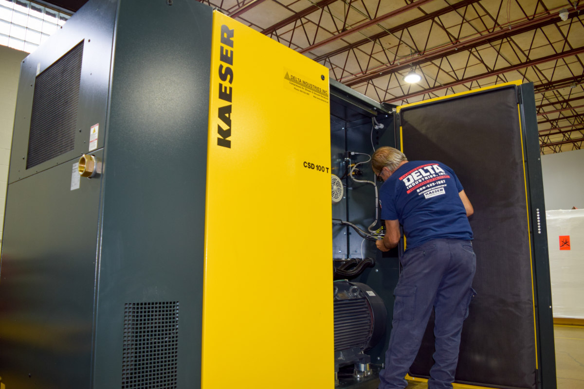 Technician working on an air compressor